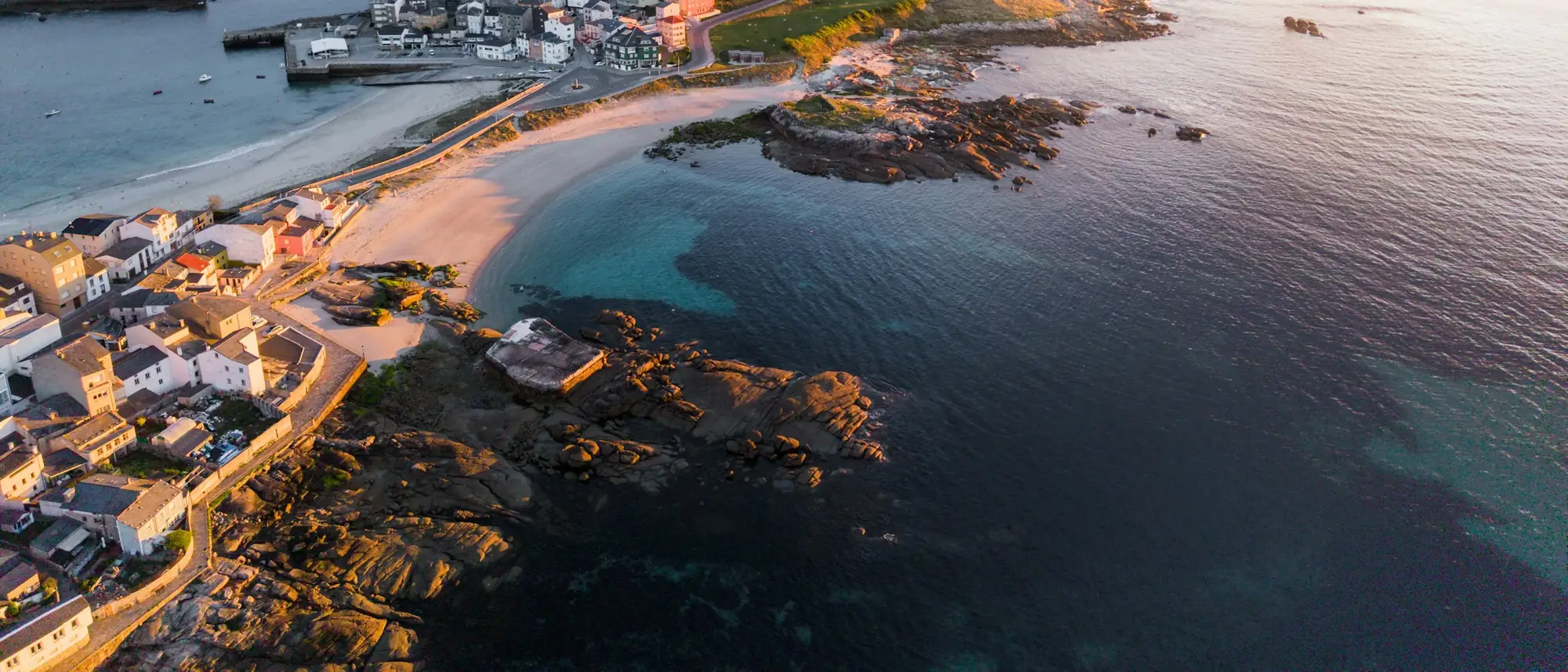 A small coastal town at sunset, seen from the air