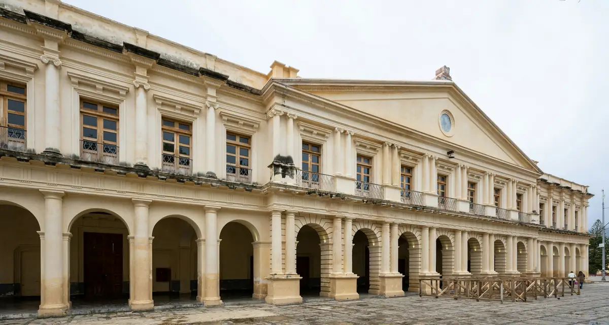 A long stone arcade of arches along a quiet plaza