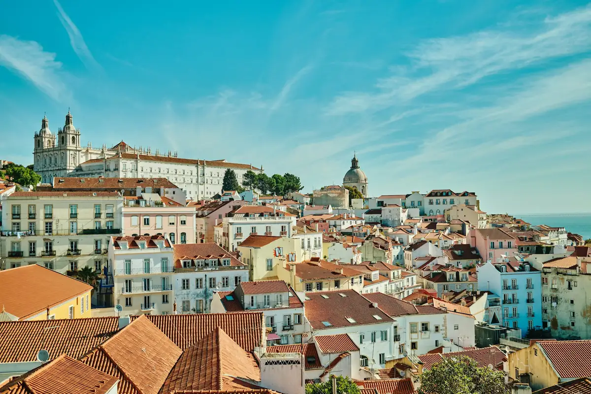 Tiled rooftops and a church dome above the river