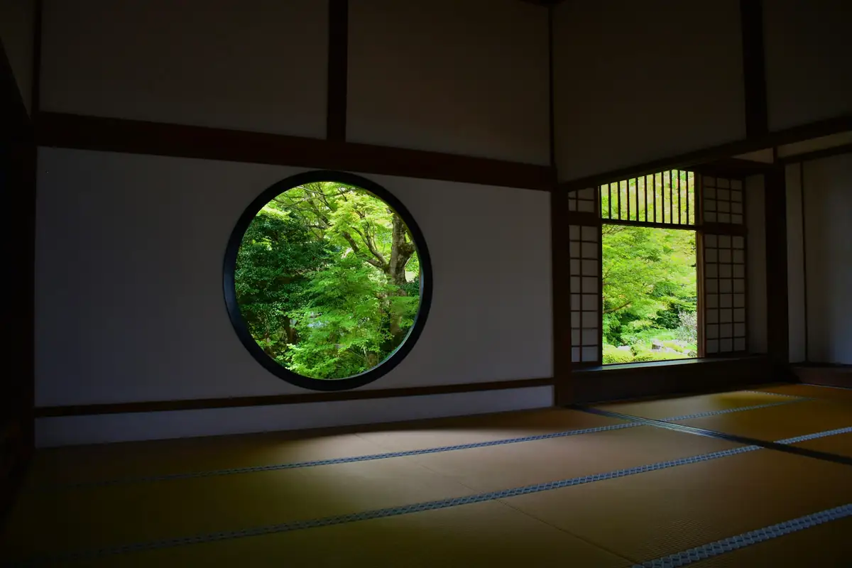 A round window framing the garden from a tatami room